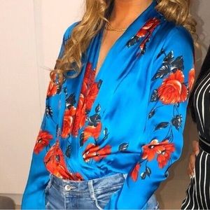 Wrap style v neck floral pattern bodysuit in blue and orange. Size small